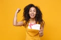 Laughing young african american woman girl in casual t-shirt posing isolated on yellow orange wall background. People Royalty Free Stock Photo