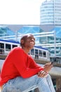 Laughing young african man sitting outside using cellphone Royalty Free Stock Photo