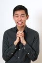 Laughing young Asian man looking at camera Royalty Free Stock Photo