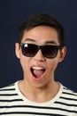 Laughing young Asian man in sunglasses Royalty Free Stock Photo