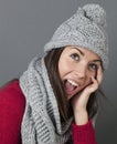 Laughing young blonde woman smiling for warmth and cozyness in winter Royalty Free Stock Photo