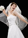 Laughing young bride in wedding dress and veil