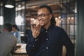 Laughing young businessman talking on speakerphone at work Royalty Free Stock Photo