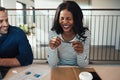 Laughing young businesswoman sitting with a colleague in an offi Royalty Free Stock Photo