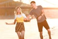 laughing young couple having fun on river beach Royalty Free Stock Photo