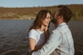 Laughing young couple on lake