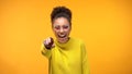 Laughing young female pointing finger in camera, having fun, joking, positivity Royalty Free Stock Photo