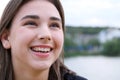 Laughing young girl with brown hair fluttering on a wind Royalty Free Stock Photo