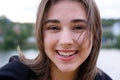 Laughing young girl with brown hair fluttering on a wind Royalty Free Stock Photo