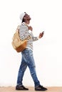 Laughing young guy walking with bag and phone Royalty Free Stock Photo