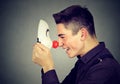 Laughing young man with clown mask Royalty Free Stock Photo