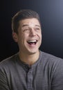 Laughing young man looking up, vertical portrait Royalty Free Stock Photo