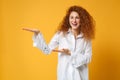 Laughing young redhead woman girl in white shirt posing isolated on yellow orange wall background studio portrait Royalty Free Stock Photo