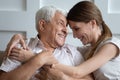 Laughing young 30s woman embracing happy older father. Royalty Free Stock Photo