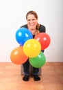 Laughing woman with colorful balloons