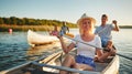 Laughing young woman canoeing with friends in the summer Royalty Free Stock Photo