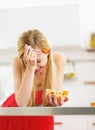Laughing young woman eating fresh fruits salad in kitchen Royalty Free Stock Photo