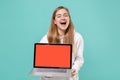 Laughing young woman girl in casual white hoodie posing isolated on blue turquoise background in studio. People Royalty Free Stock Photo