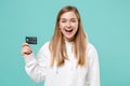 Laughing young woman girl in casual white hoodie posing isolated on blue turquoise background studio portrait. People Royalty Free Stock Photo