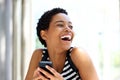 Laughing young woman holding mobile phone Royalty Free Stock Photo