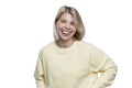 Laughing young woman. Pretty blonde in a yellow sweater. Happiness, positivity and freedom. Isolated on white background