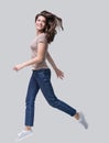 Laughing young woman running, having fun and enjoying life, beautiful joyful girl looking up full length portrait