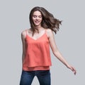 Laughing young woman running, having fun and enjoying life, beautiful joyful girl looking up full length portrait