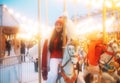 Laughing young woman at the winter fair riding a horse, carousel, Royalty Free Stock Photo