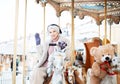 Laughing young woman at the winter fair riding a horse, carousel Royalty Free Stock Photo