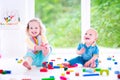 Laughings brother and sister playing with colorful block Royalty Free Stock Photo