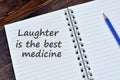Laughter is the best medicine words on notebook Royalty Free Stock Photo