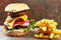 Laughter is brightest where food is best. a delicious triple decker hamburger with fries.