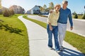 Laughter is at the center of their relationship. a happy senior couple waking around their neighborhood together. Royalty Free Stock Photo