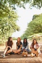 Laughter is an instant vacation. A group of multiracial teens sitting outdoors enjoying each others company. Royalty Free Stock Photo