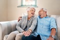 Laughter is key to a happy life. a senior couple relaxing together on the sofa at home. Royalty Free Stock Photo