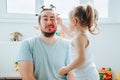 Laughter and Lipstick A Funny Father-Daughter Moment Captured Forever Royalty Free Stock Photo