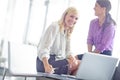 Laughter in the office. Portrait of two laughing female work colleagues with a laptop in front of them with copyspace. Royalty Free Stock Photo