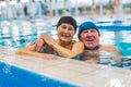 Laughter at swimming pool side. Togetherness and marriage concept. Happy laughing caucasian senior adult couple hugging Royalty Free Stock Photo