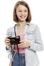 Laughting cute teen girl with a camera, close-up, isolated on white background