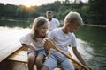 Brother and sister learning to paddle canoe with their father Royalty Free Stock Photo