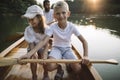 Kids enjoy nature by canoeing with father Royalty Free Stock Photo