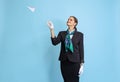 Half-length portrait of beautiful young girl, flight attendant in black uniform posing isolated on blue studio