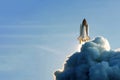 The launch of the space shuttle against the background of the sky and smoke. Elements of this image furnished by NASA