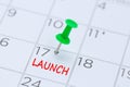 LAUNCH written on a calendar with a green push pin to remind you