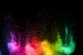 Colorful background of pastel powder.Multi colored dust splash on black background.Painted Holi