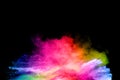 Launched colorful powder on black background.Color powder explosion.Colorful dust splashing