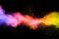 Launched colorful powder on black background.Color powder explosion.Colorful dust splashing