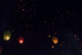 Swarms paper lanterns flying in the beautiful dark sky.