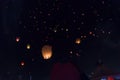 Swarms thousand orange paper lanterns flying in the dark sky