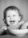 Launching child eat. Smiling baby eating food. Family, food, child, eating and parenthood concept. Royalty Free Stock Photo